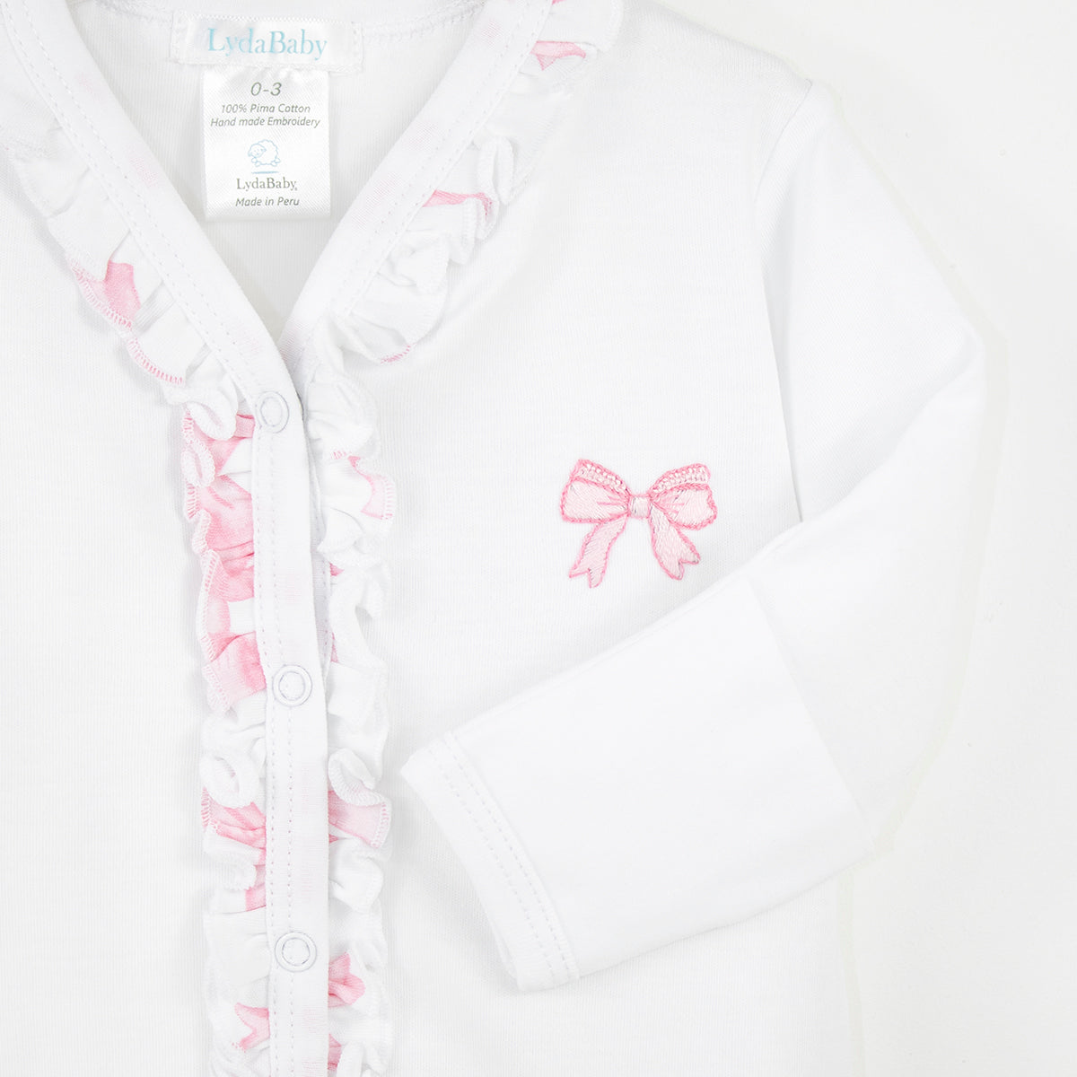 Luxury white baby girl footie with V-neck, pink bow embroidery, and ruched snap details