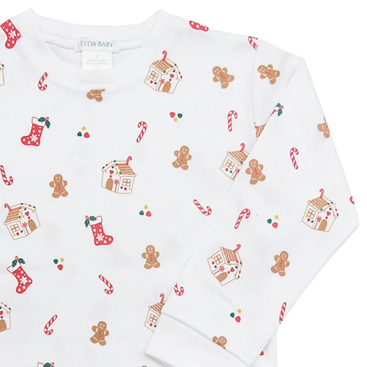 Unisex Christmas pajama set in Peruvian Pima cotton, white with gingerbread houses, cookies, stockings, candy canes print and red crochet trim on collar and cuffs.