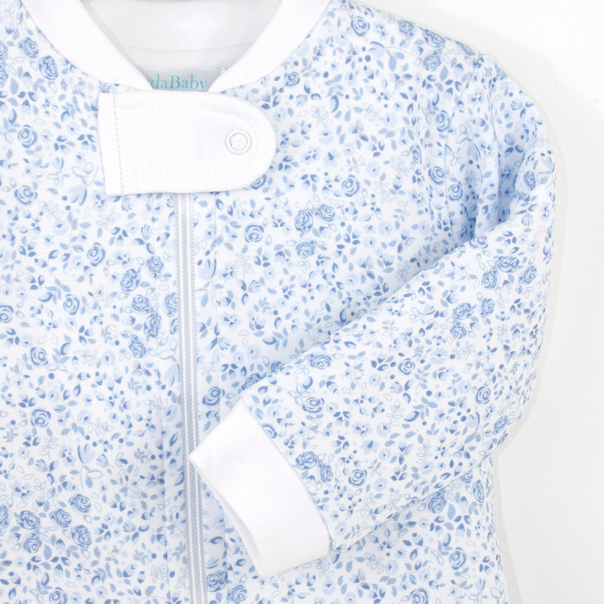 Elegant baby girl zipper featuring blue roses print on premium Peruvian Pima cotton — soft, breathable, and delicate.