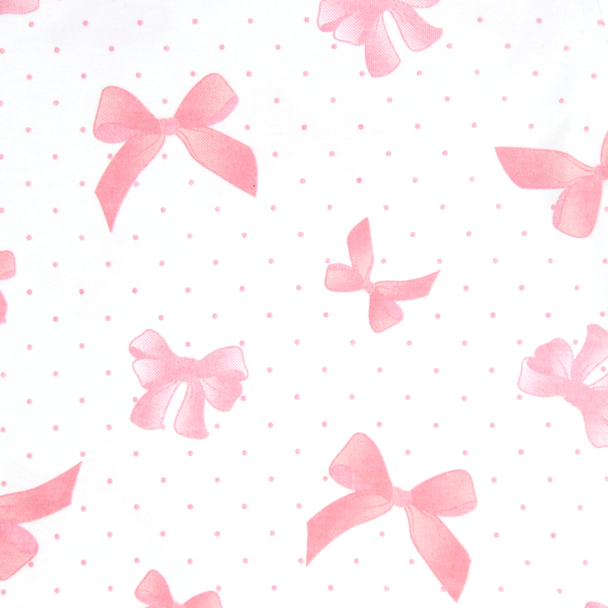 White baby girl bonnet in Pima cotton with pink polka dots, large bow prints, and white ties under the chin.