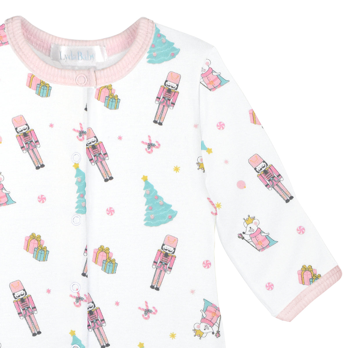 Luxury baby girl Christmas footie made from Peruvian Pima cotton, white with nutcracker, ballerina, Christmas tree and gift box print, long sleeves and pink trim.