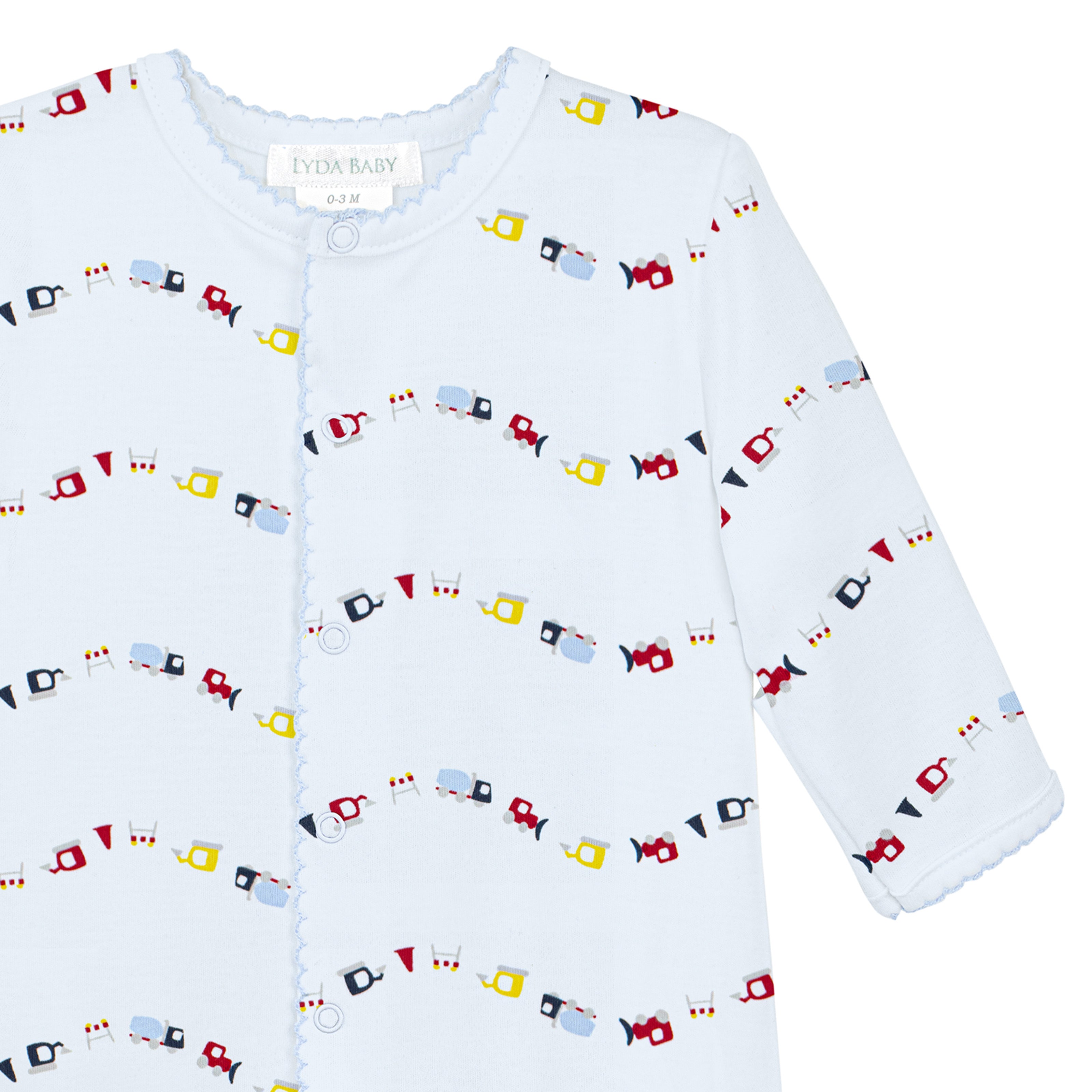 Blue baby boy footie with mini trucks print in Peruvian Pima cotton.