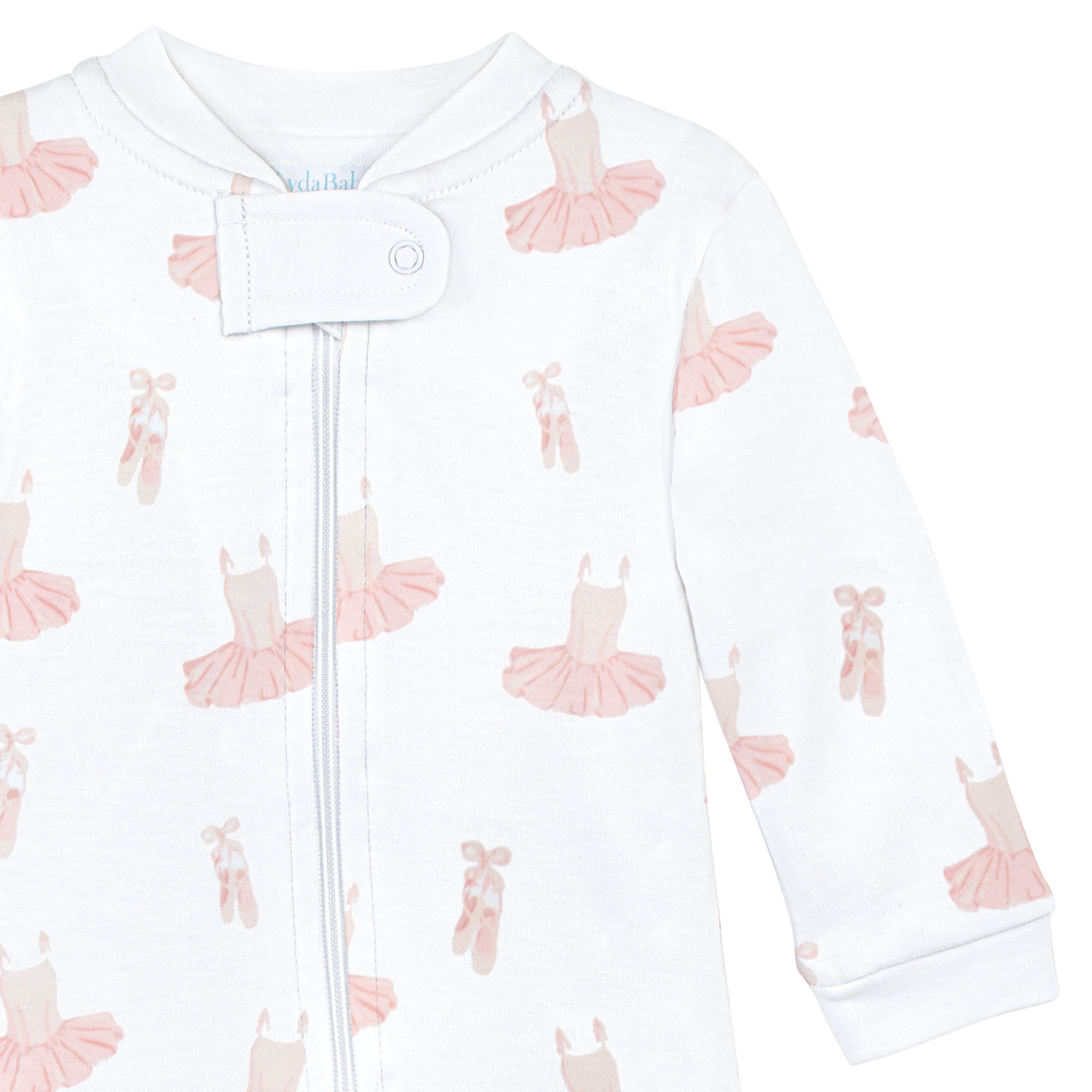 White newborn zip onesie with ballerina dresses print in Peruvian Pima cotton.