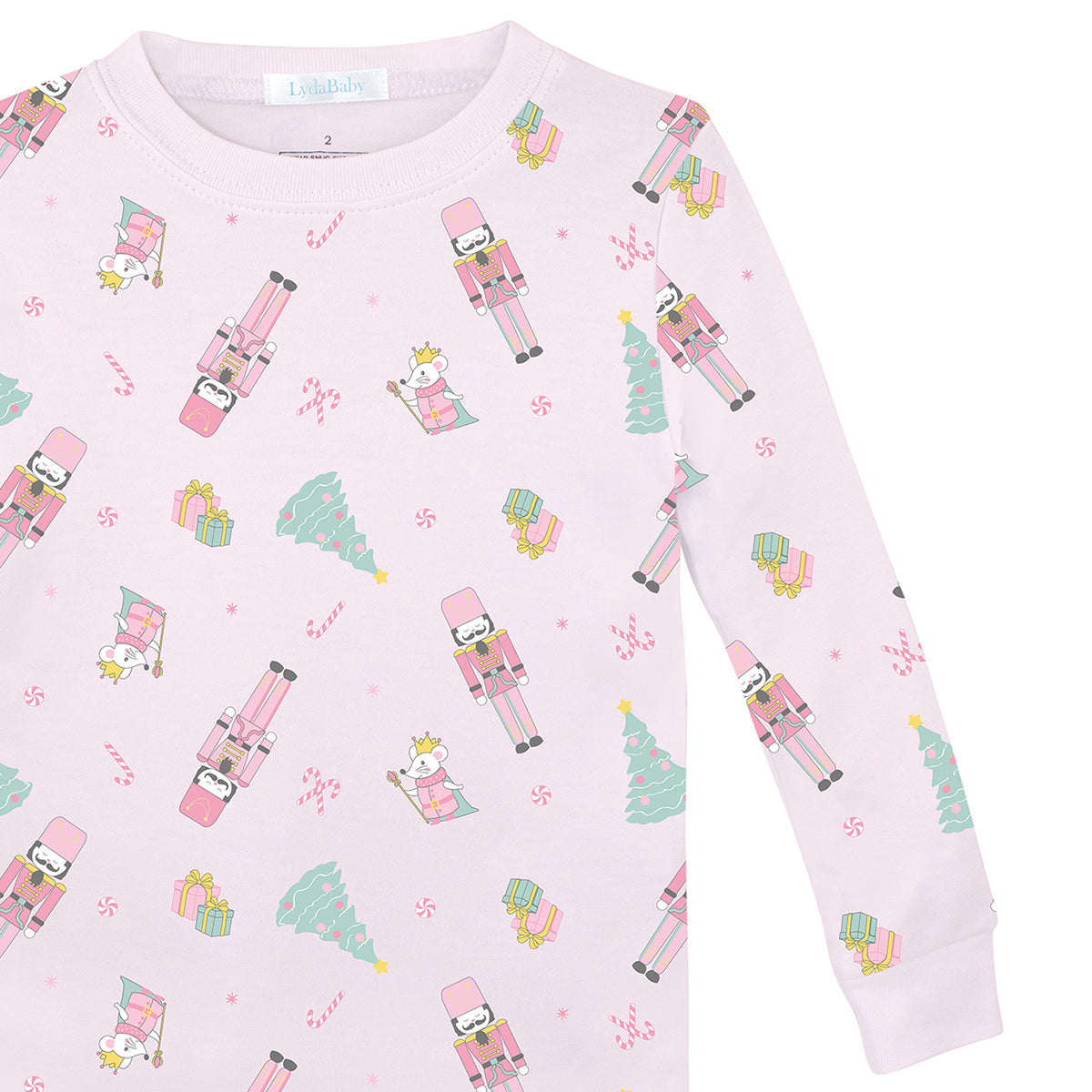 Pink two-piece girls’ pajama set in Peruvian Pima cotton with festive nutcracker and Christmas tree print.