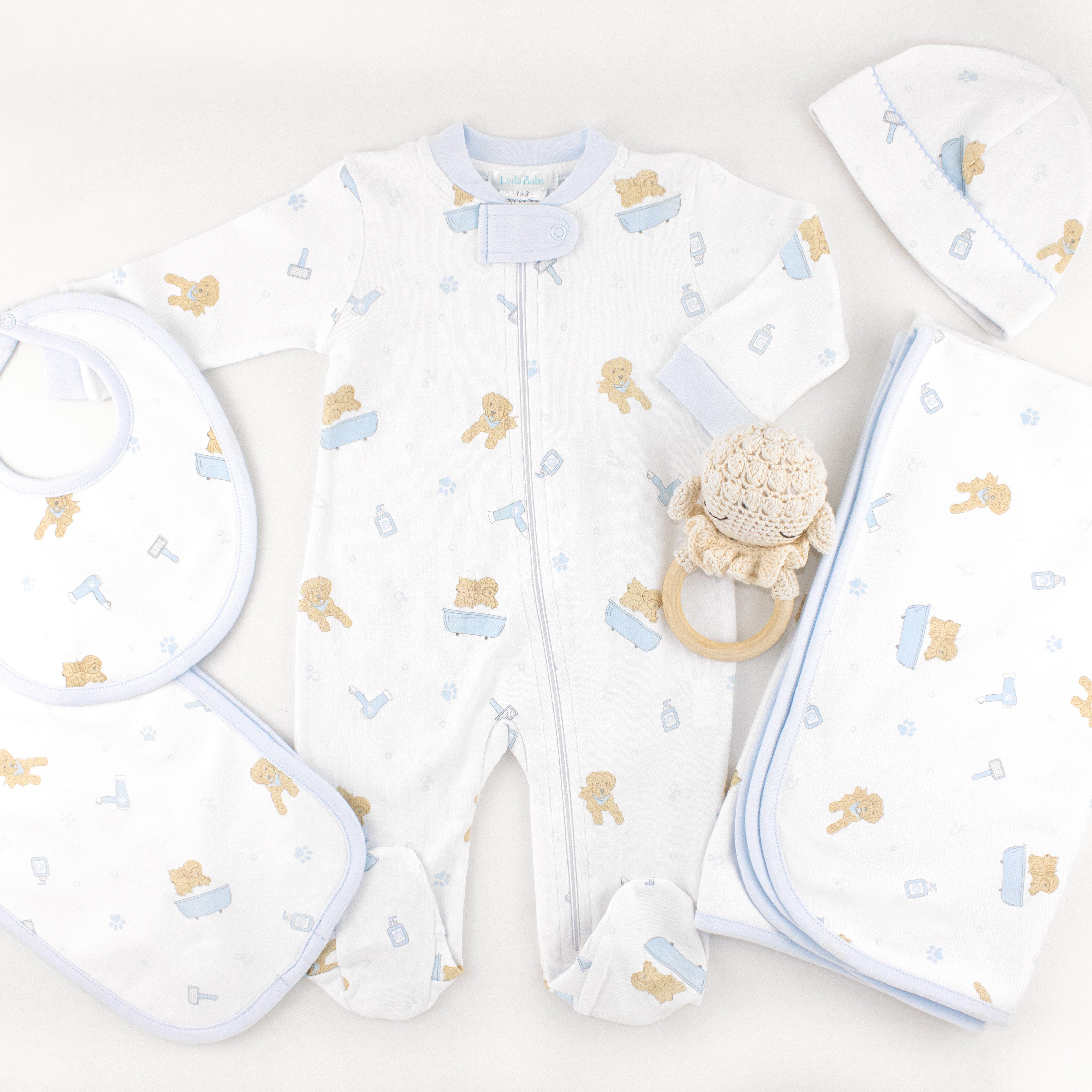 Newborn baby boy gift set in Peruvian Pima cotton featuring blue “Pet Spa” print — includes footie, blanket, hat, bib, and burp cloth for a coordinated and luxurious look.