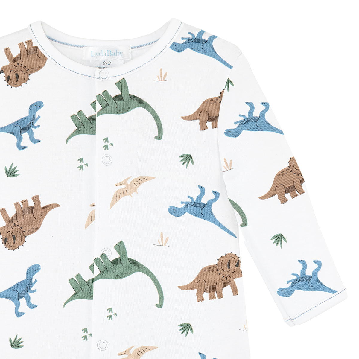 White baby boy footie with all-over dinosaur print in brown, green, and blue.