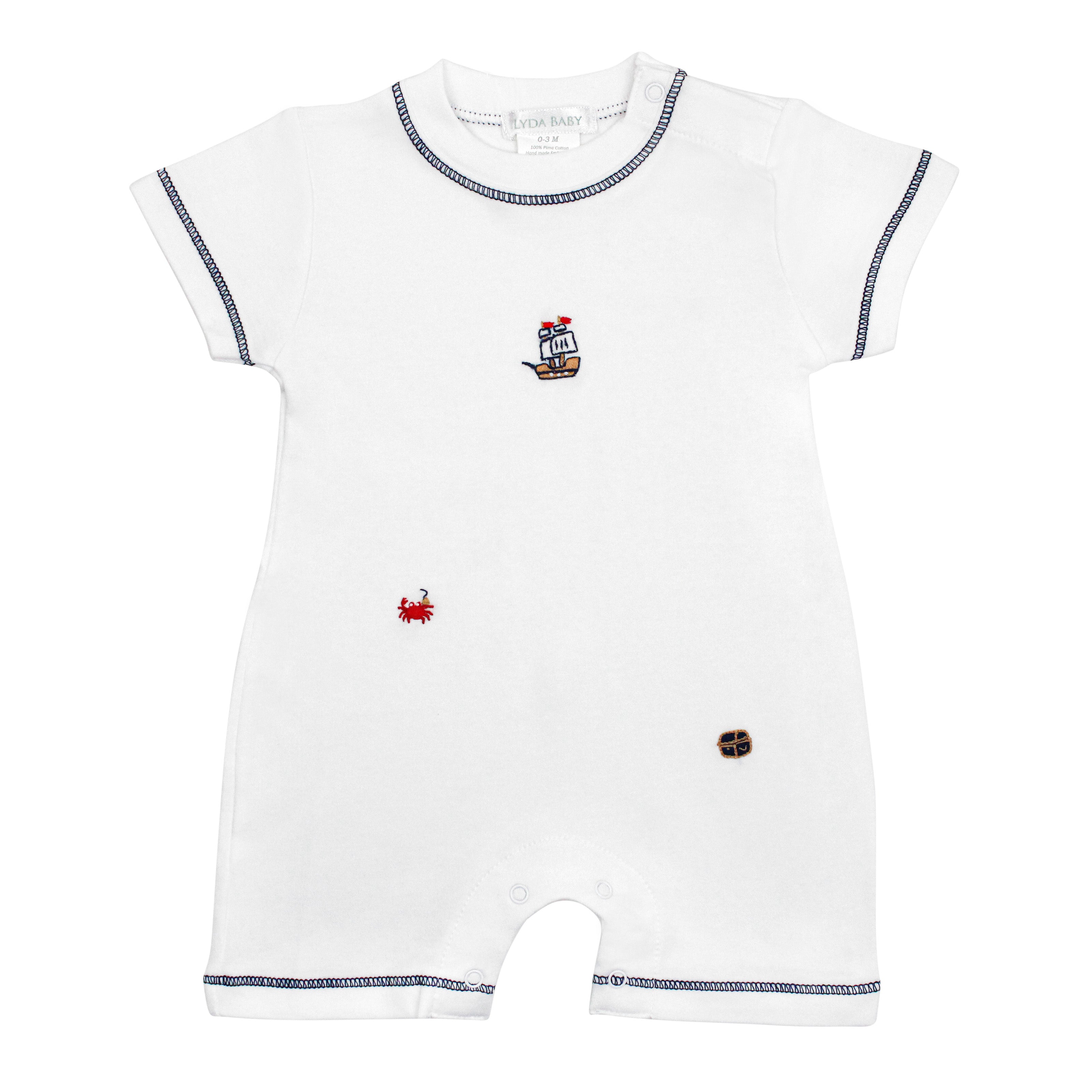 White baby boy romper with blue stitching, hand-embroidered pirate crab, ship, and treasure chest.