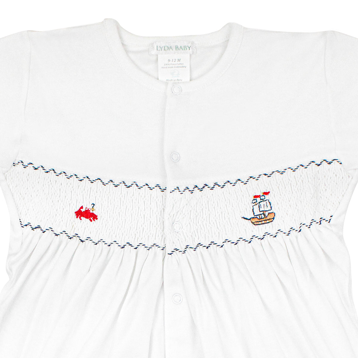 White baby romper with short sleeves, smock chest, embroidered red crab and pirate ship, snap closures.