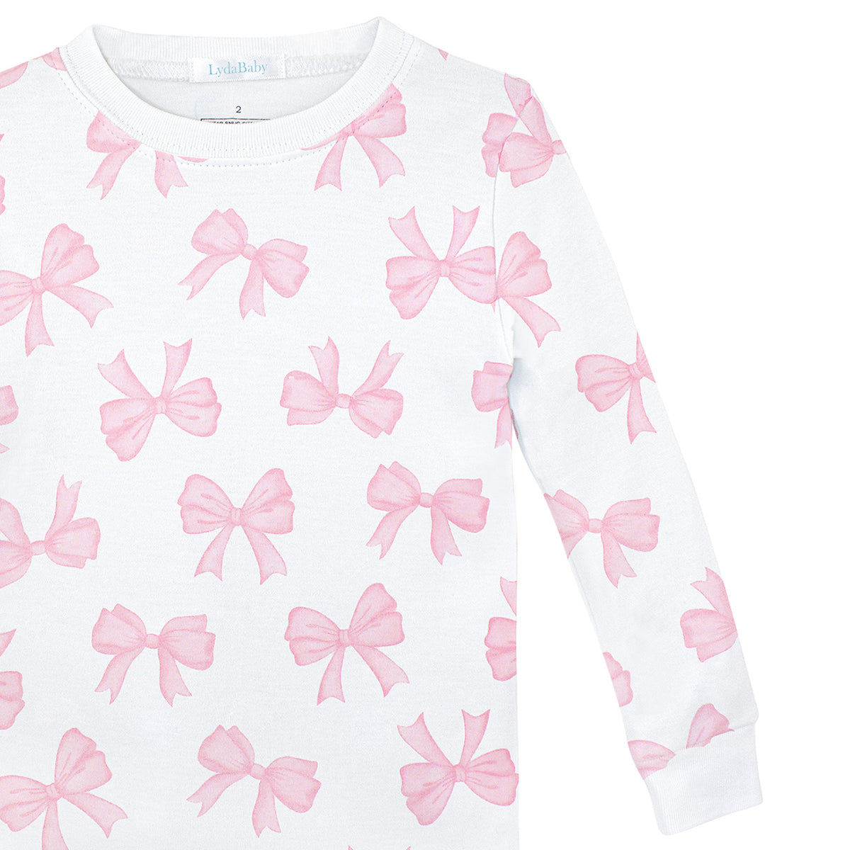 Soft baby girl pajama set in Peruvian Pima cotton with 'Watercolor bows' print — breathable and hypoallergenic luxury sleepwear from boutique baby clothing collections.