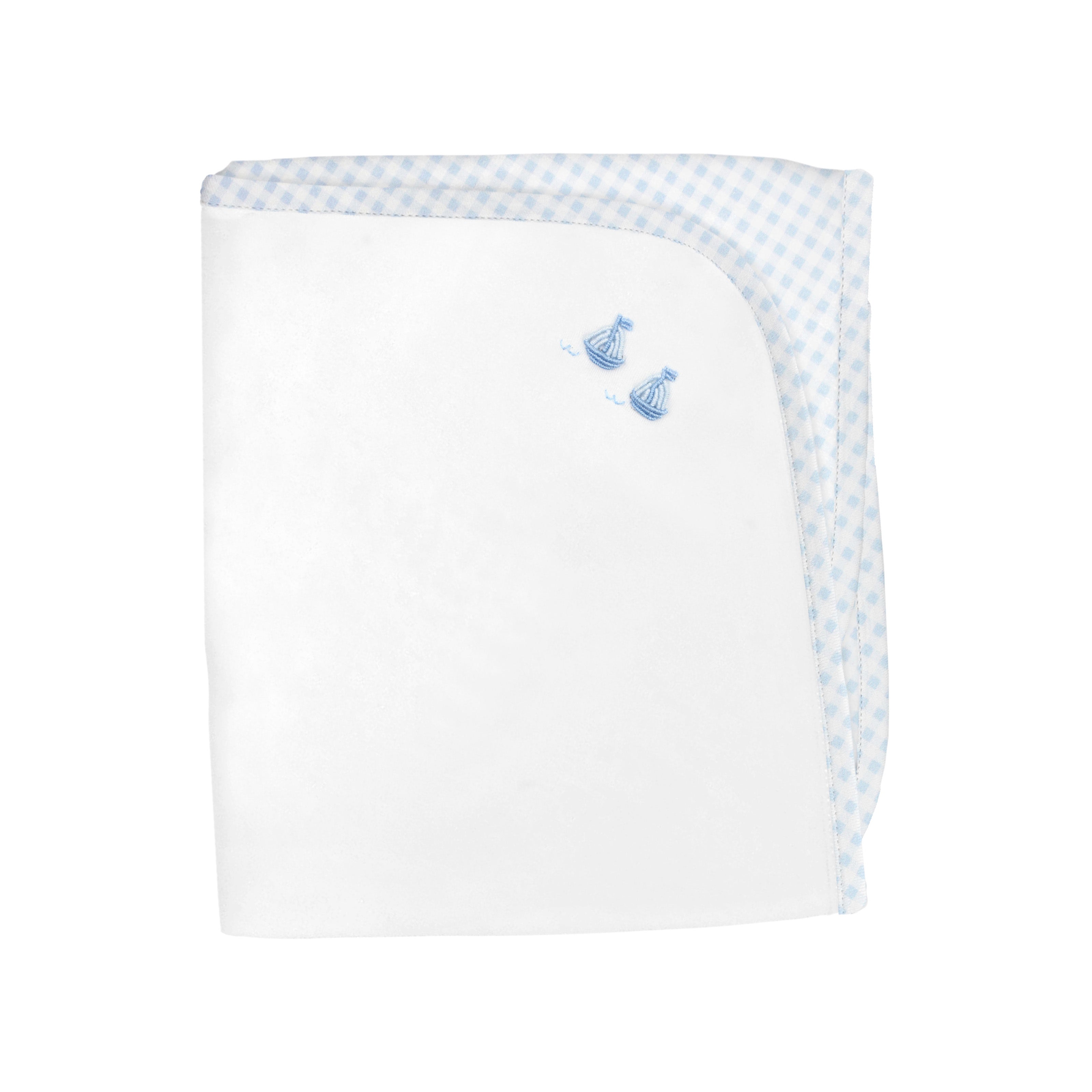Luxury reversible baby blanket featuring blue gingham vichy print on one side and soft white fabric with embroidered sailboats crafted in premium Peruvian Pima cotton.