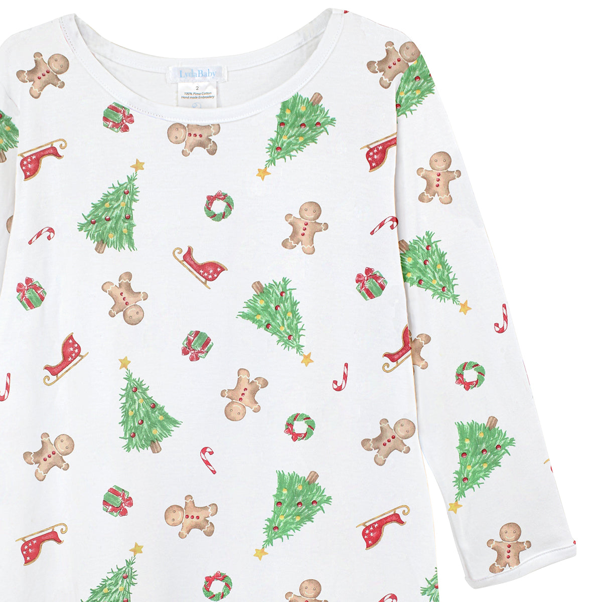 Luxury Christmas baby girl dress, long-sleeve, Peruvian Pima cotton with holiday print of trees, Santa’s sleigh, gingerbread cookies, and gifts.