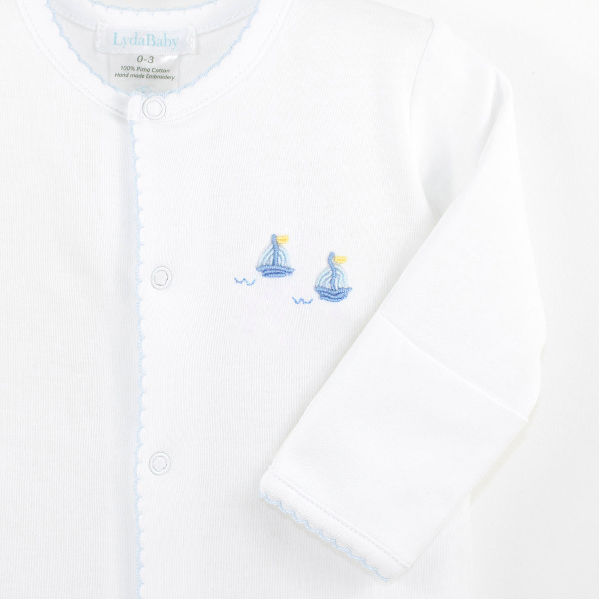 Luxury baby boy footie in Peruvian Pima cotton with hand-embroidered sailing boats on the chest