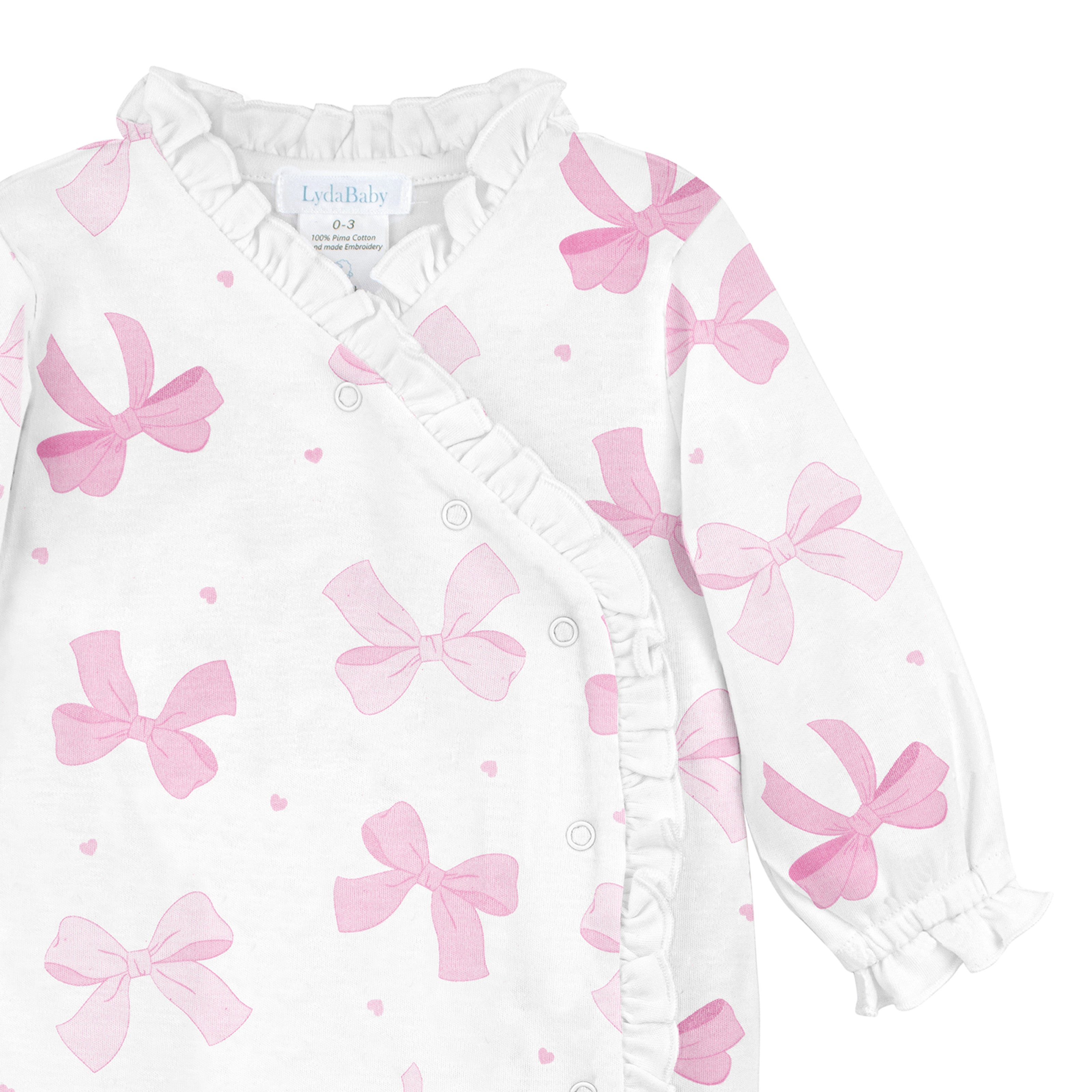 Baby girl cross snap footie with pink bow print and ruffle details made from Peruvian Pima cotton. Lydababy