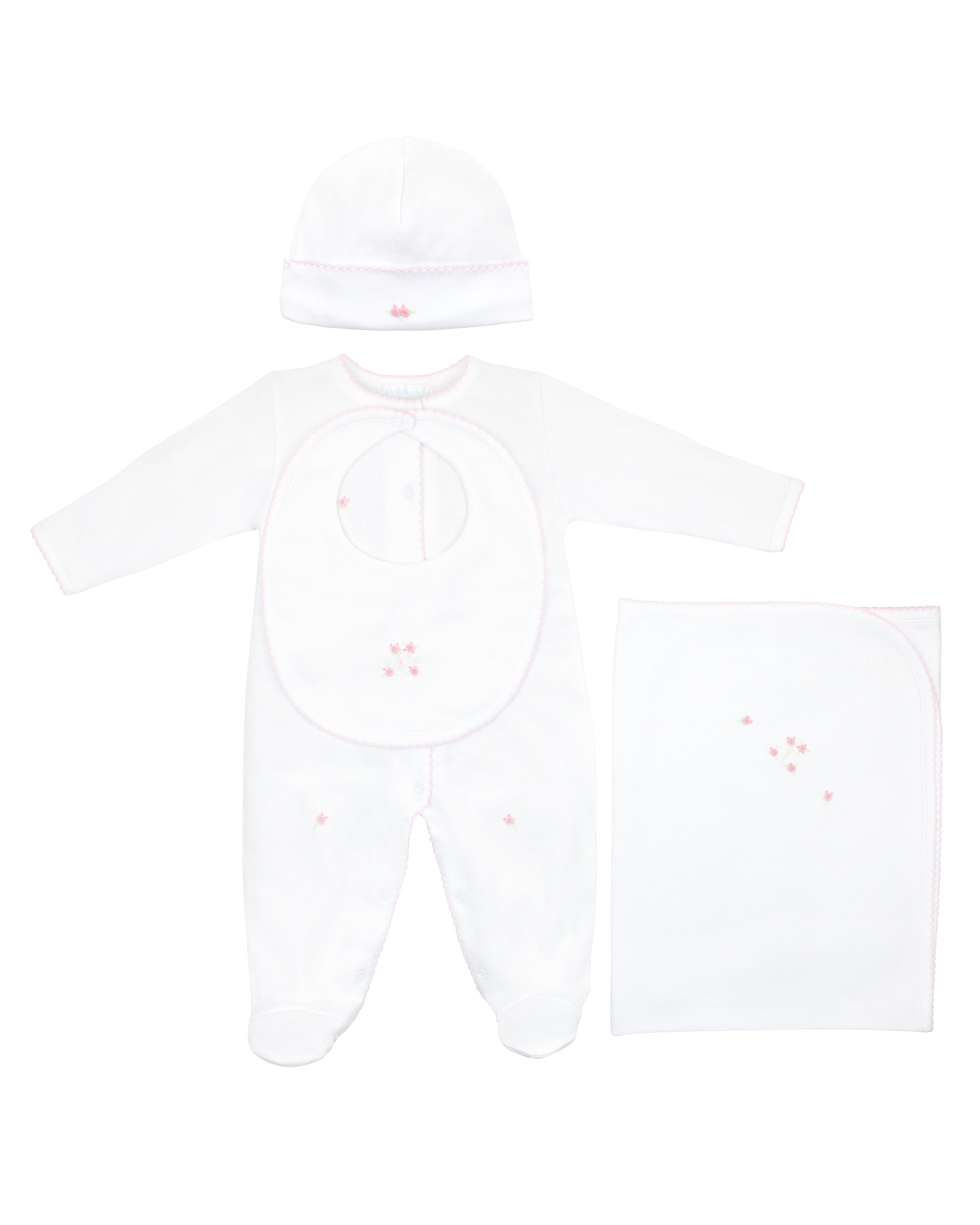 Refined 4-piece baby girl set in pure white Peruvian Pima cotton, featuring hand-embroidered pink roses on footie, hat, bib, and blanket — ultra-soft, breathable, and ideal for special occasions or elegant everyday wear.