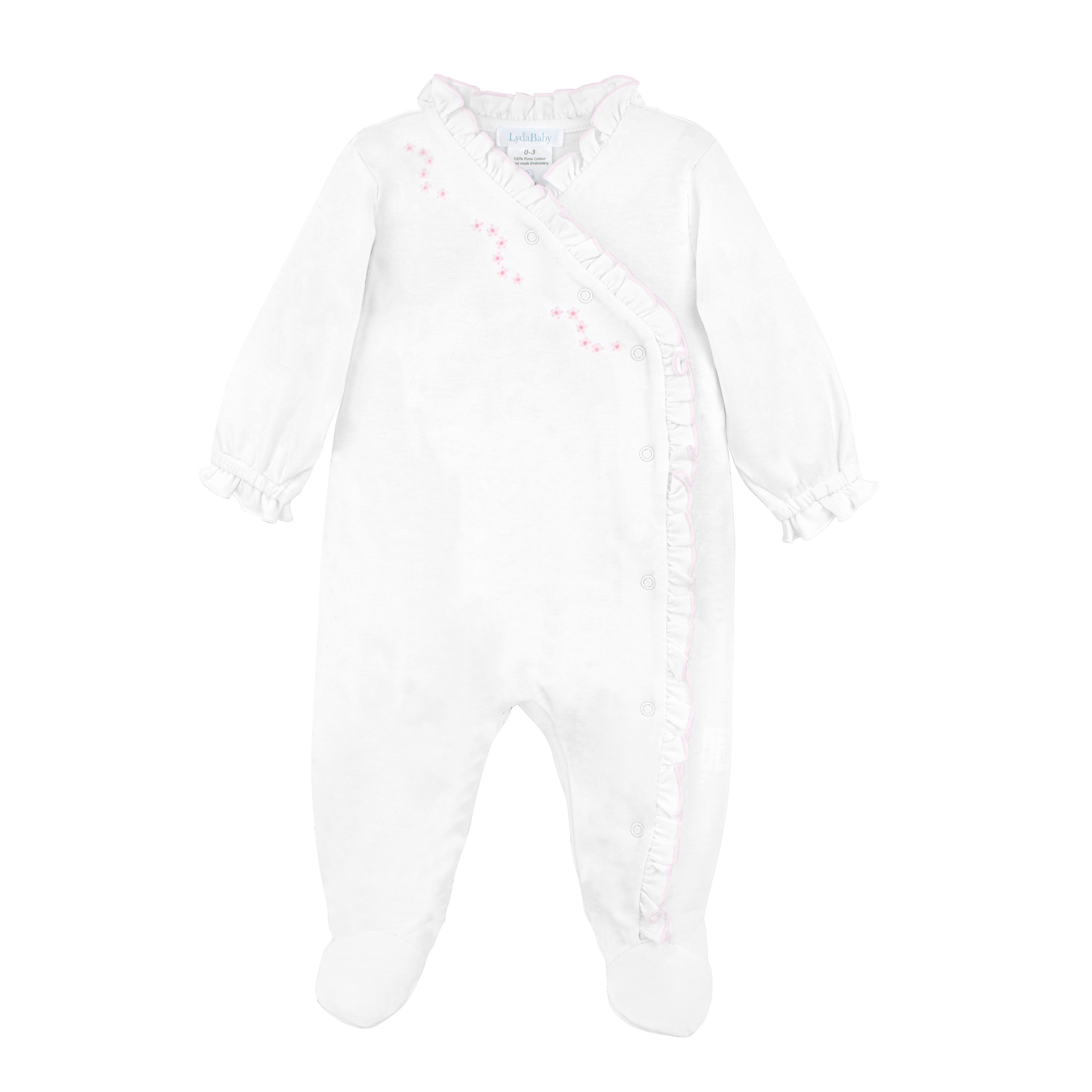  Hand-embroidered baby girl footie with delicate spring blossoms, crafted from ultra-soft Peruvian Pima cotton — luxurious and artisanal comfort.
