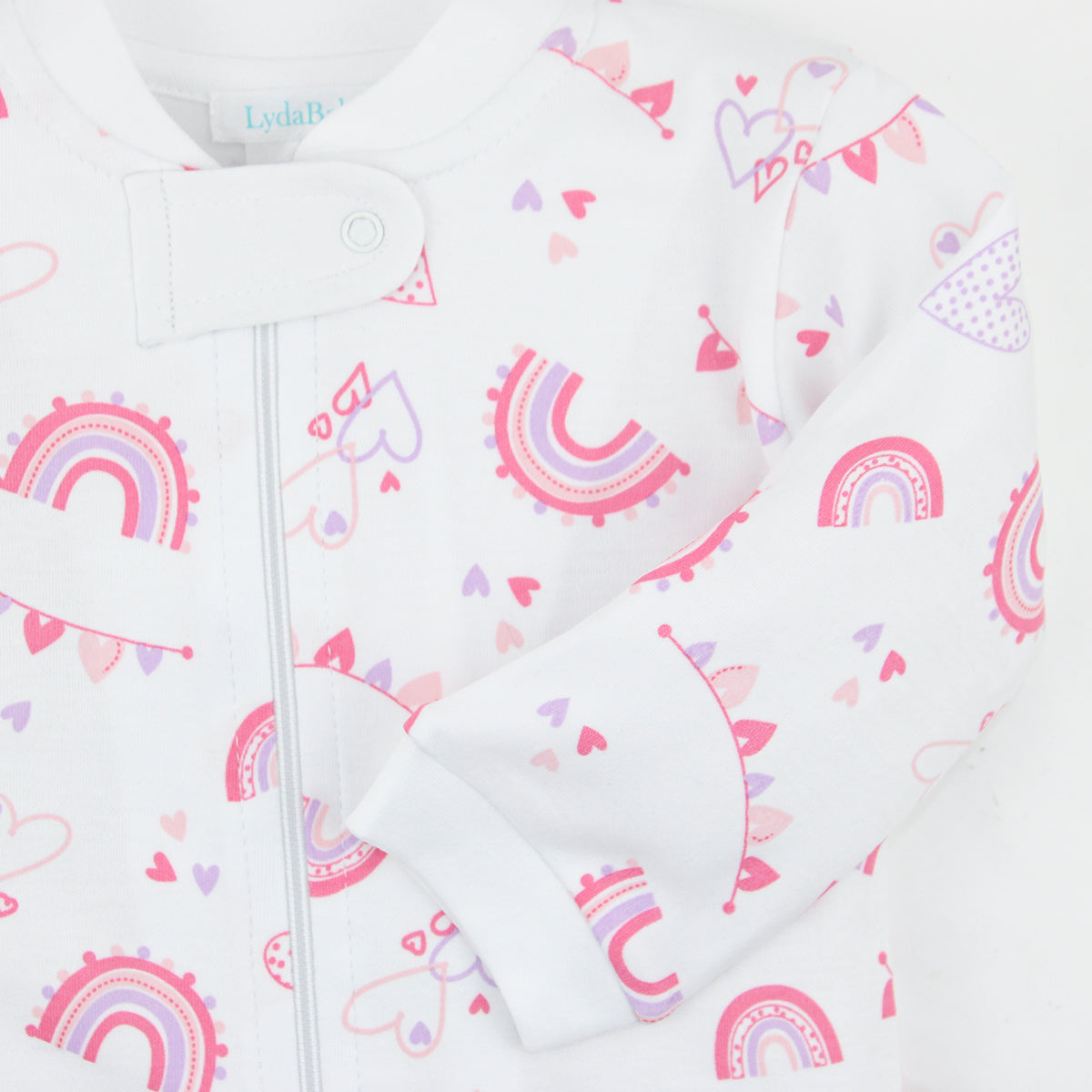  Bright baby girl zipper with rainbow and hearts print on soft organic Peruvian Pima cotton — breathable, gentle, and cozy.