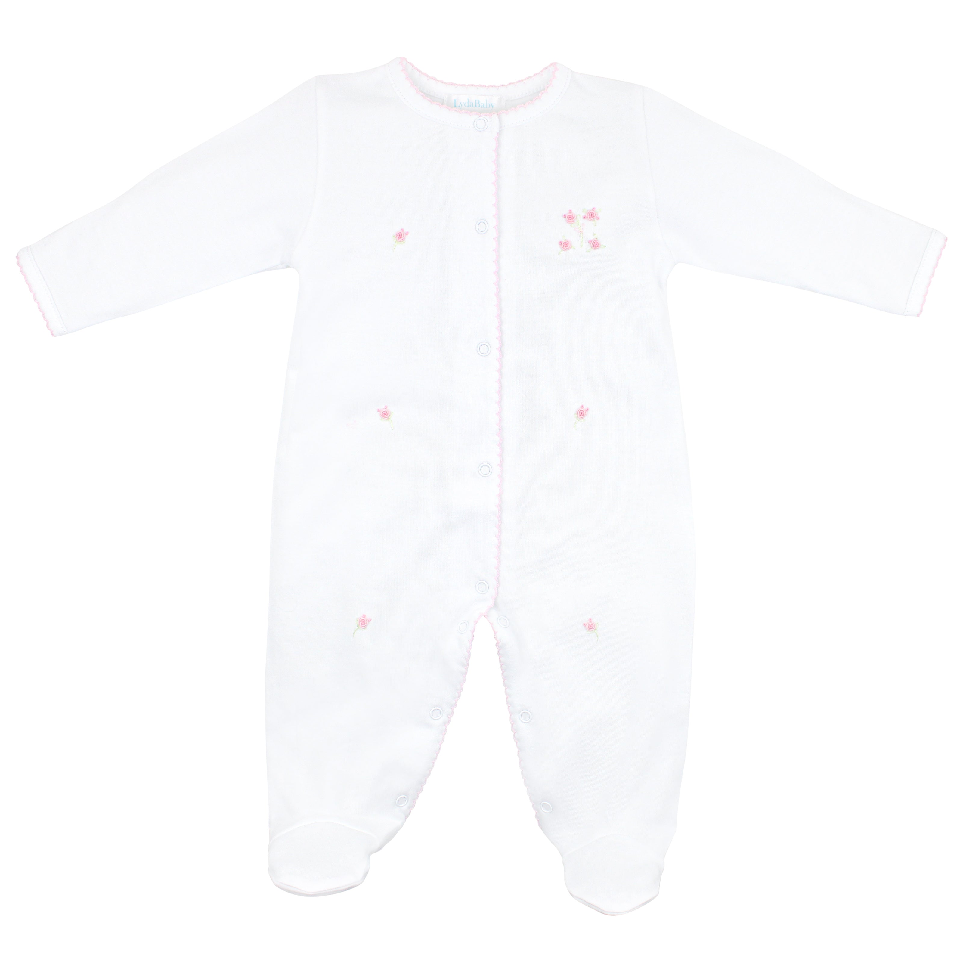Refined 4-piece baby girl set in pure white Peruvian Pima cotton, featuring hand-embroidered pink roses on footie, hat, bib, and blanket — ultra-soft, breathable, and ideal for special occasions or elegant everyday wear.