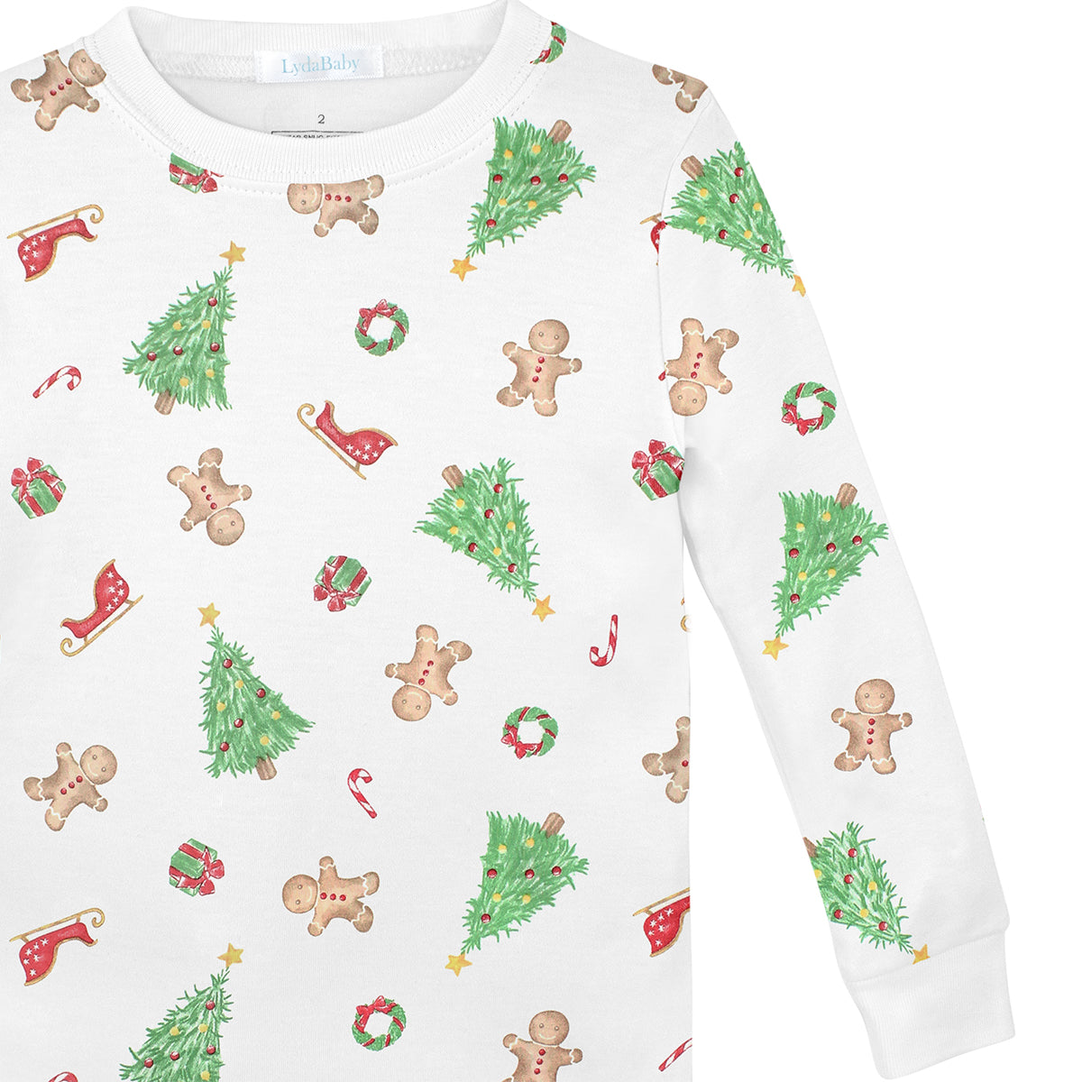 Luxury unisex baby Christmas pajama set in Peruvian Pima cotton with holiday print of trees, gingerbread cookies, candy canes, gifts, and Santa’s sleigh