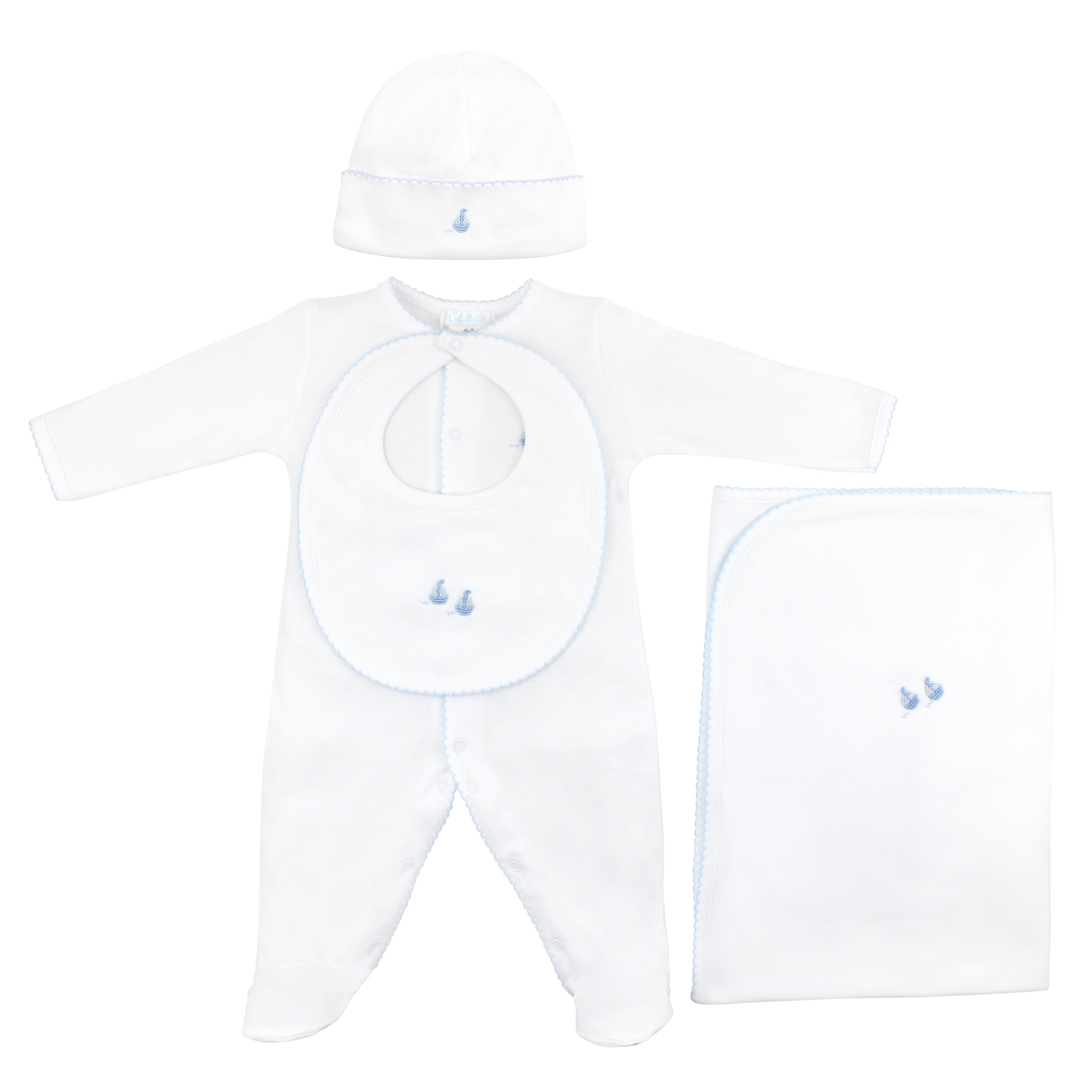 4-piece baby boy gift set with hand-embroidered sailboats, made from ultra-soft Peruvian Pima cotton — includes footie, hat, blanket, and bib for timeless newborn comfort.